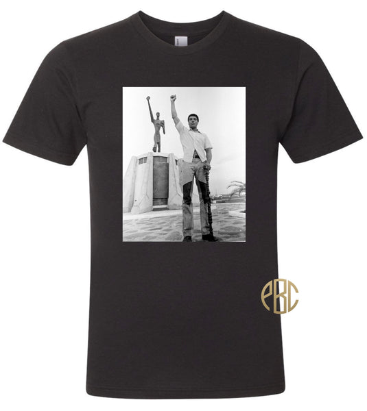 Muhammad Ali T Shirt, Muhammad Ali Posing in front of Statue Zaire T Shirt